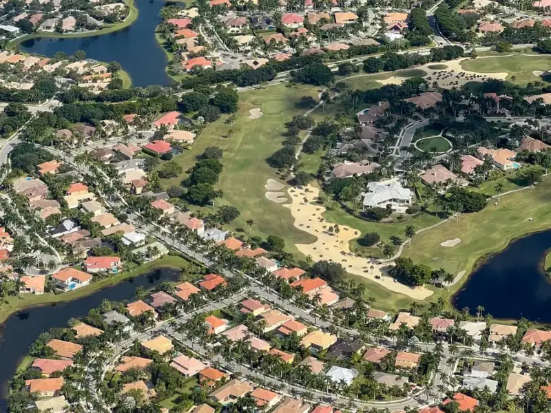 Aerial view of a Valrico / FishHawk, FL golf community with palms and lakes