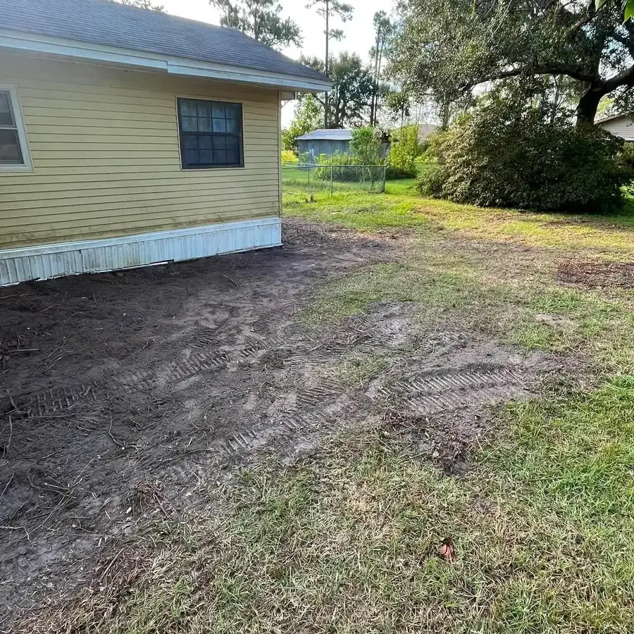 Yard cleared of brush and debris beside a home in Tampa, FL